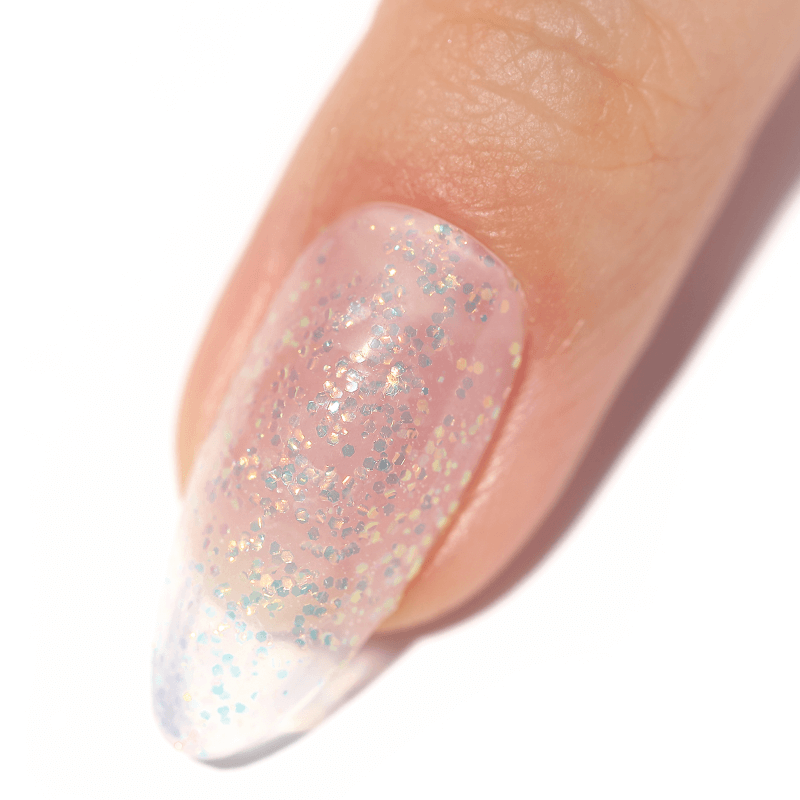 Close-up of a fingernail with glittery, translucent nail polish.