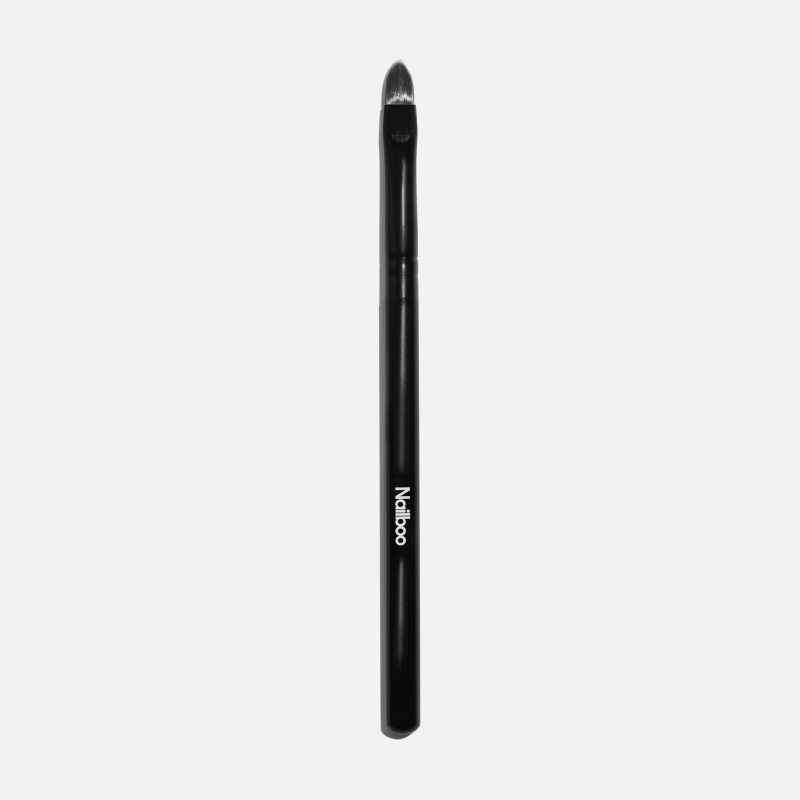 'Black nail brush with a pointed tip against a white background.'