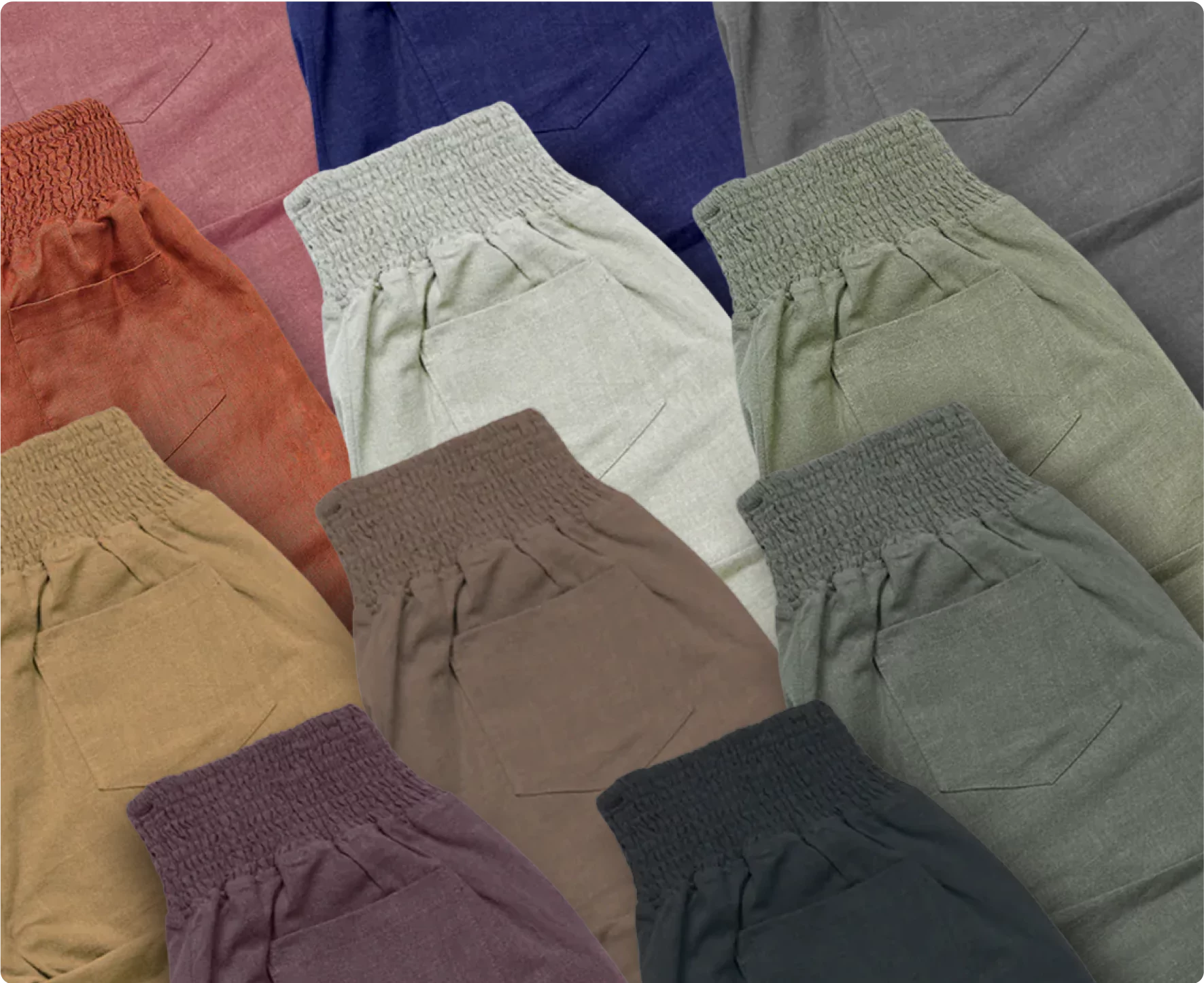 Assorted colored pants with elastic waistbands and pockets, arranged in a grid.
