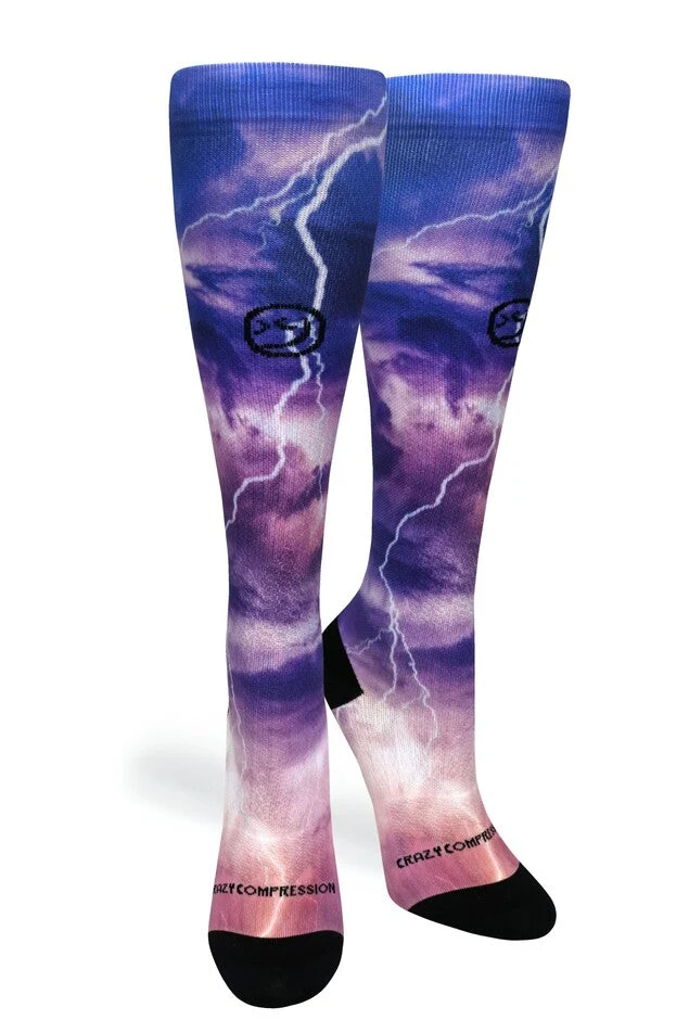 A pair of purple and blue knee-high socks with a stormy sky and lightning bolt print.
