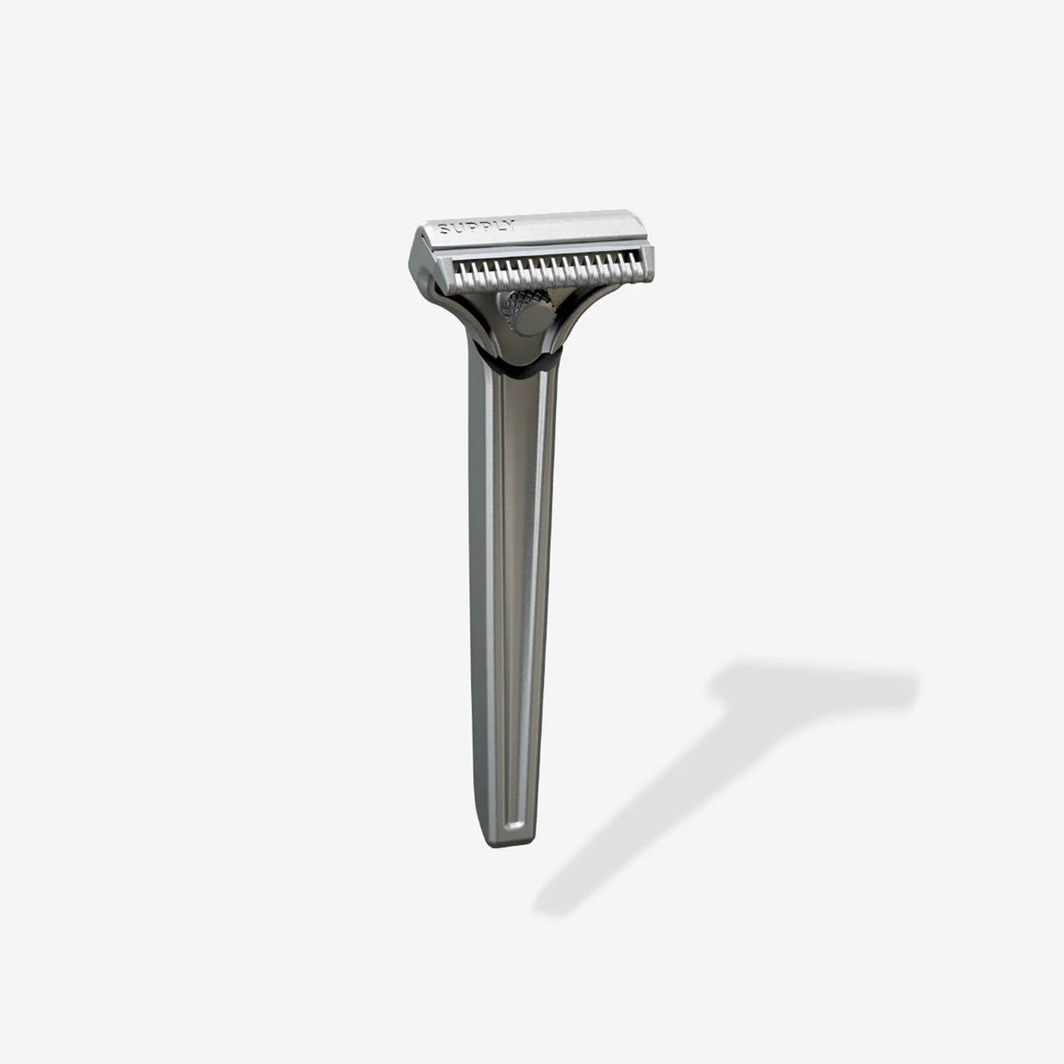 Silver safety razor with a shadow on a light background.
