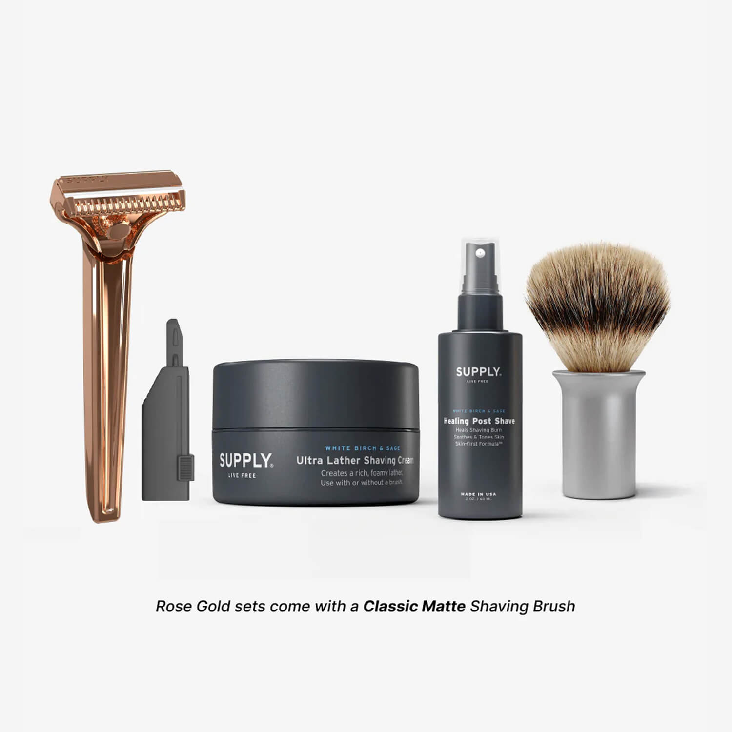 Shaving kit with razor, cream, post-shave spray, and brush on white background.