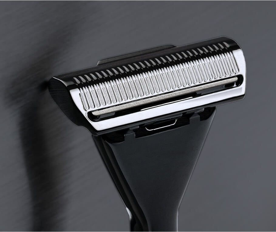 Close-up of a black and silver razor head on a dark background.