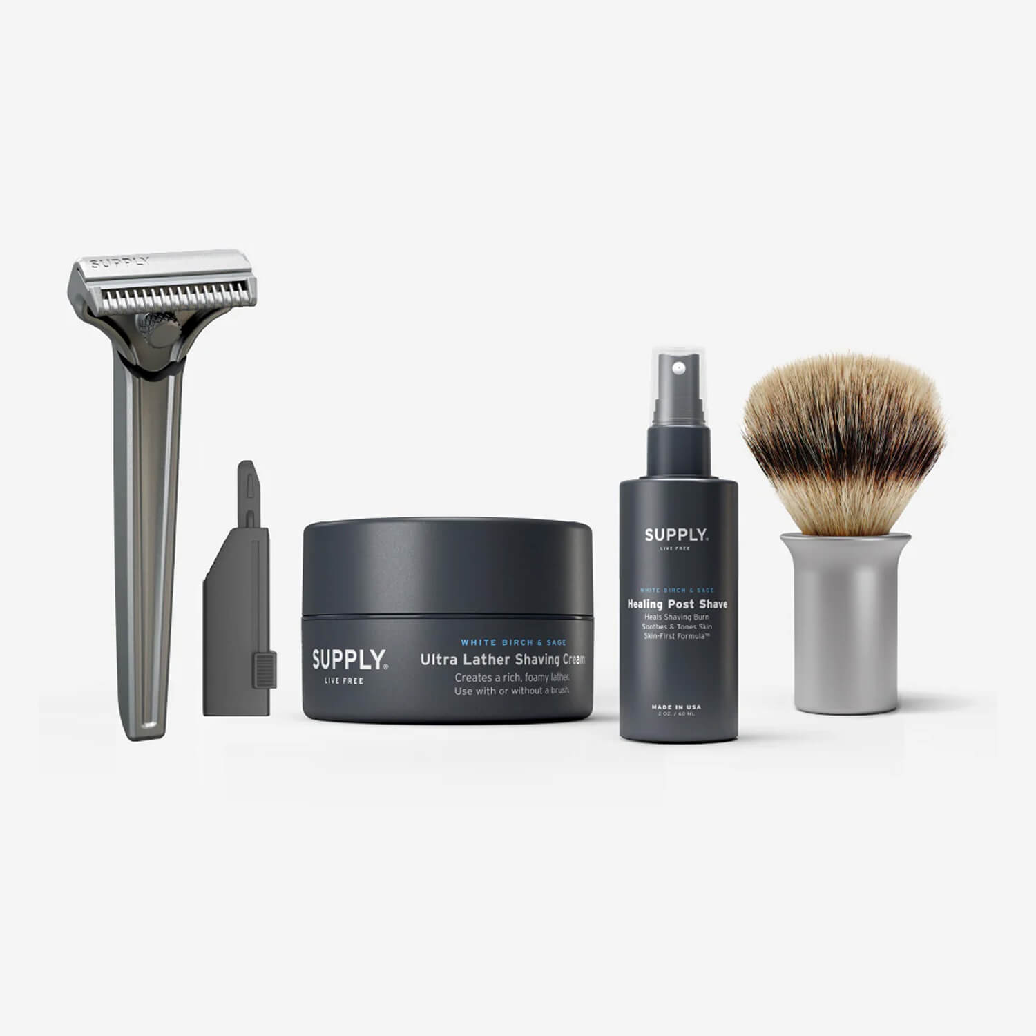 Shaving kit with razor, shaving cream, post-shave spray, and brush.