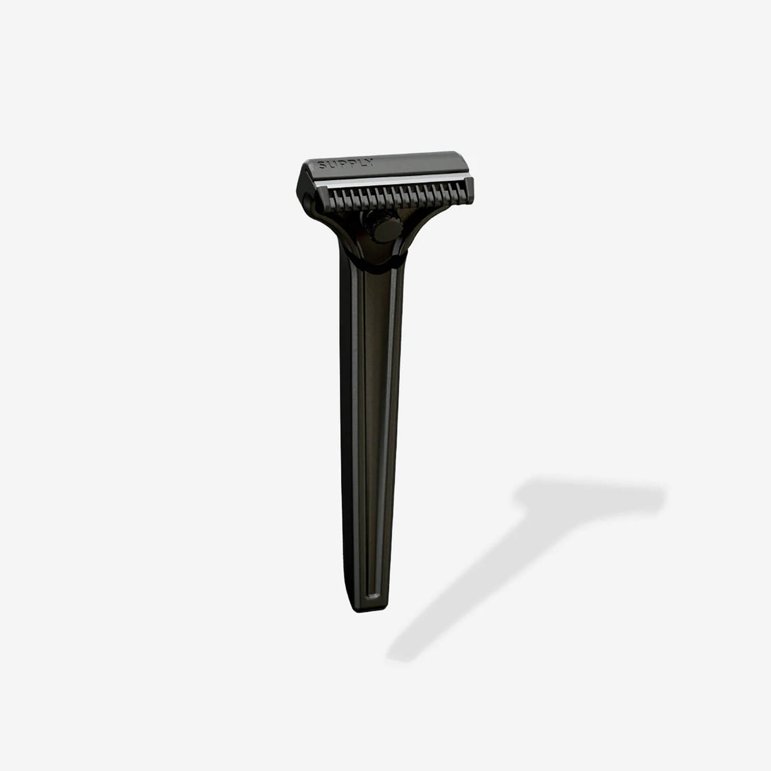 Black safety razor with a shadow on a light background.