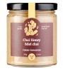 A jar of chai honey with a brown label and black lid.