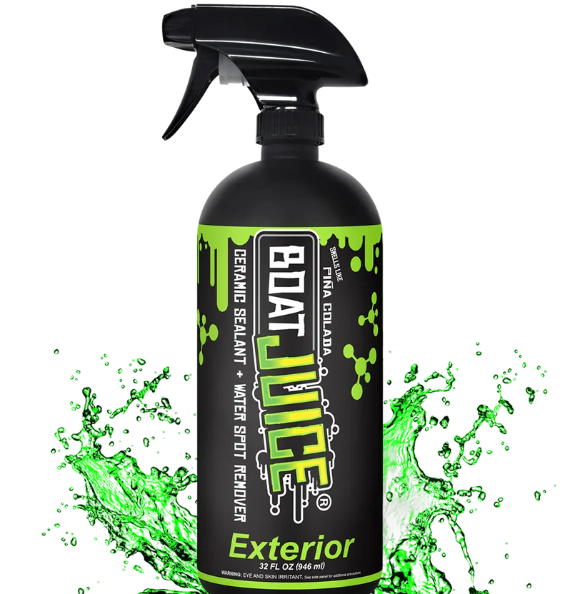 A black spray bottle of Boat Juice Exterior cleaner with a green liquid splashing around its base.
