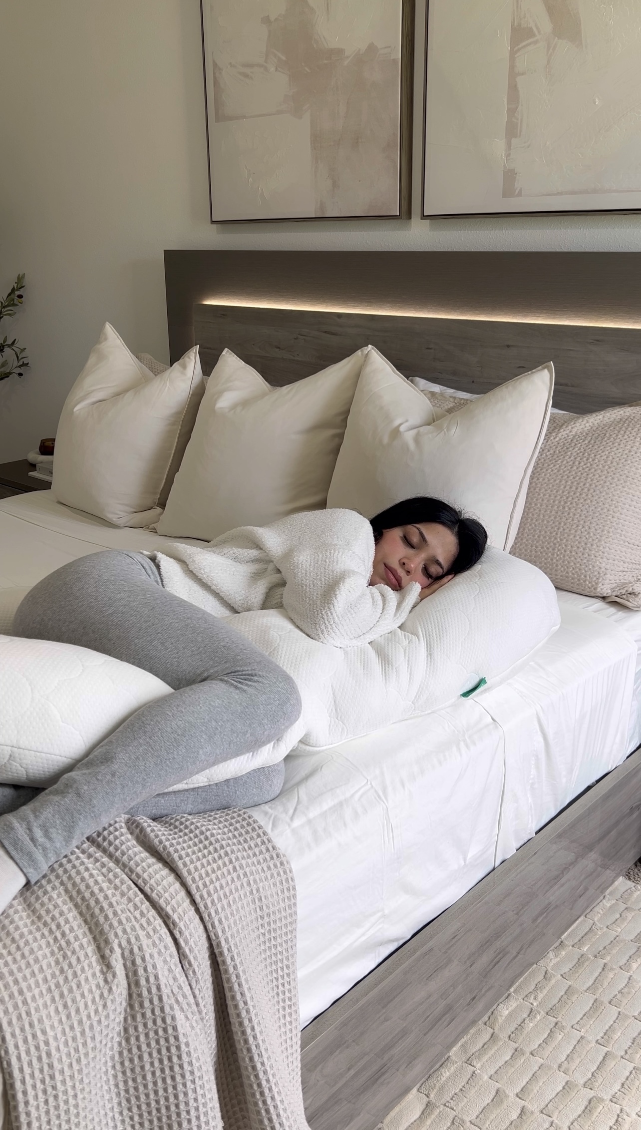 Woman peacefully sleeping on bed with The Newton Pillow