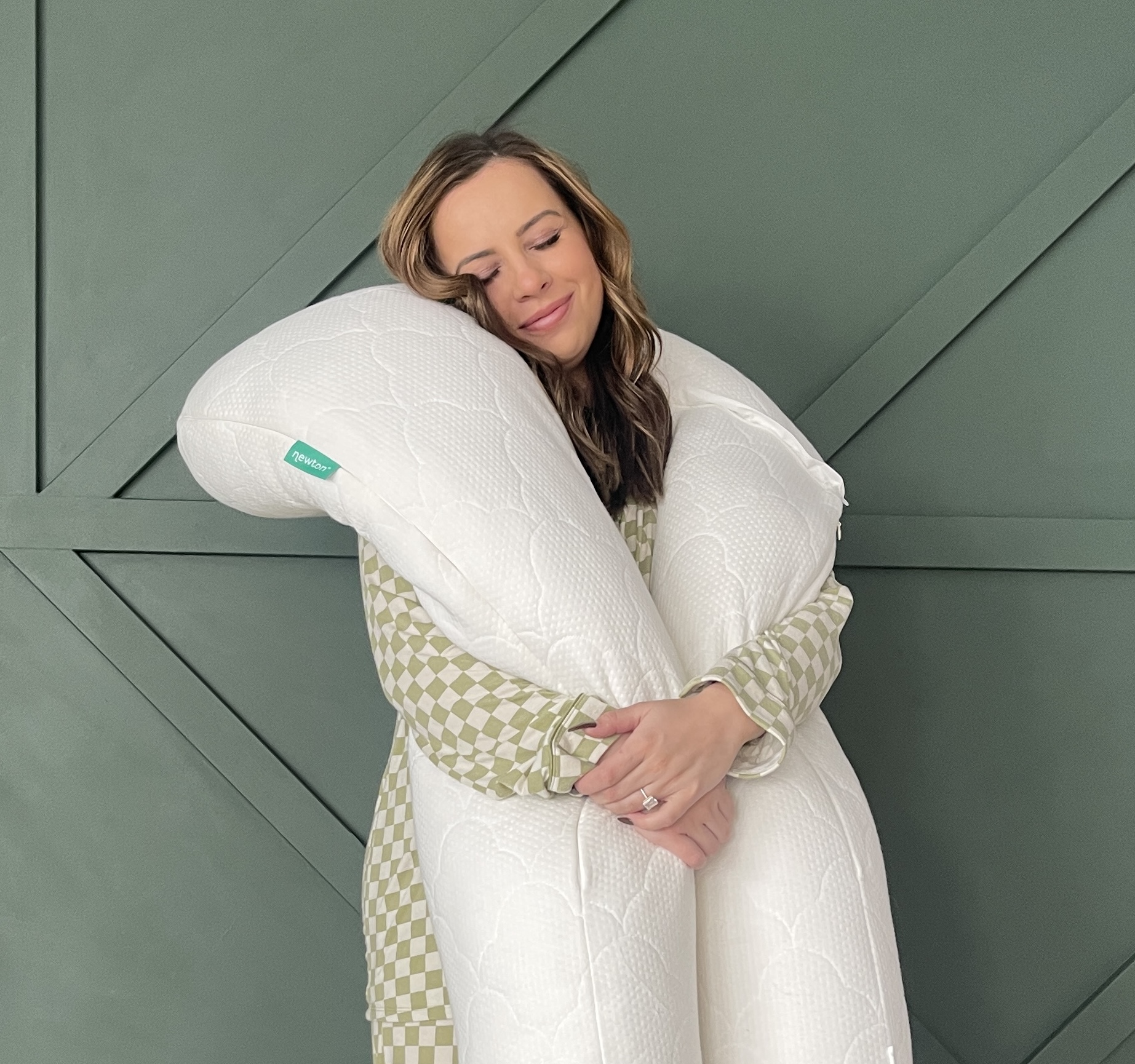 Woman hugging The Newton Pillow