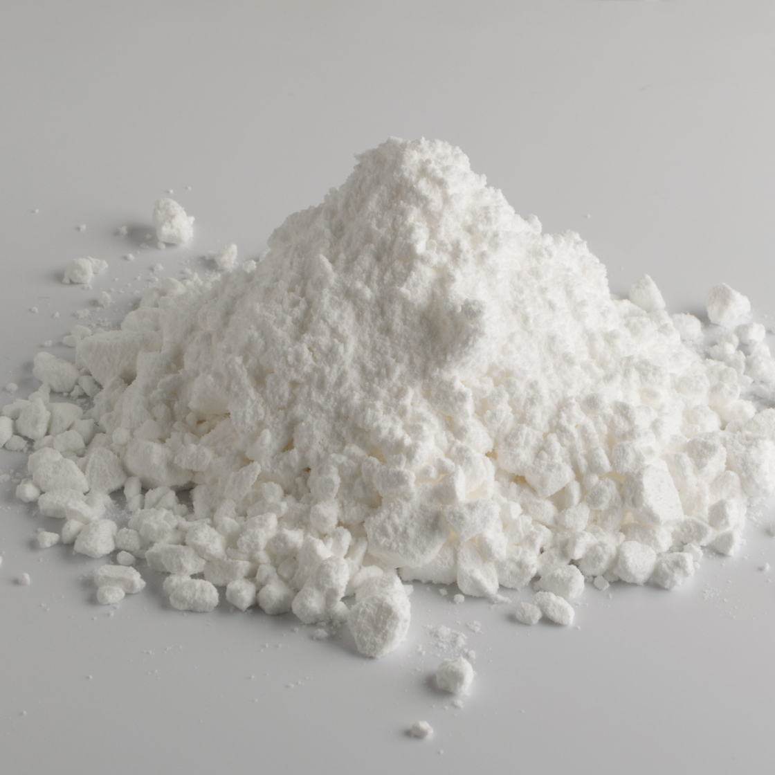 A pile of white powder on a gray surface.