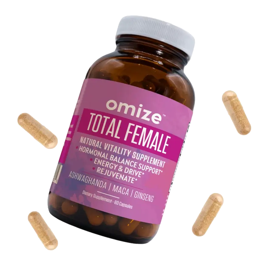 A bottle of Omize Total Female supplement with four capsules floating around it against a white background.