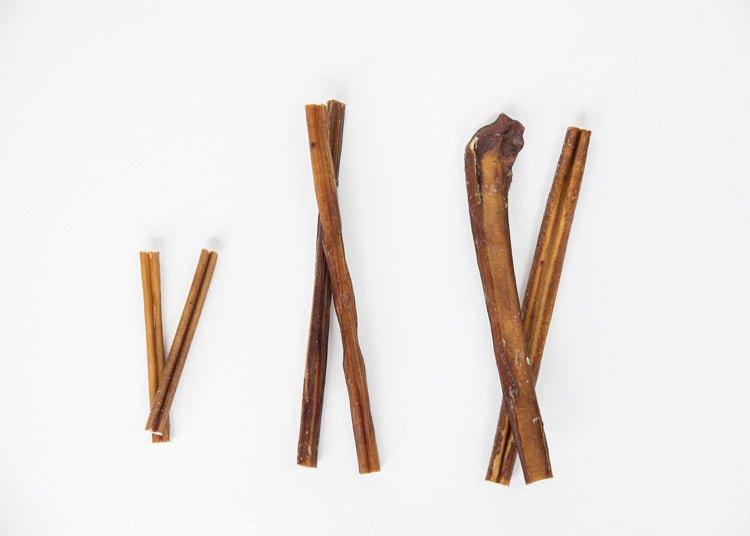 Three sets of brown sticks arranged on a white background.