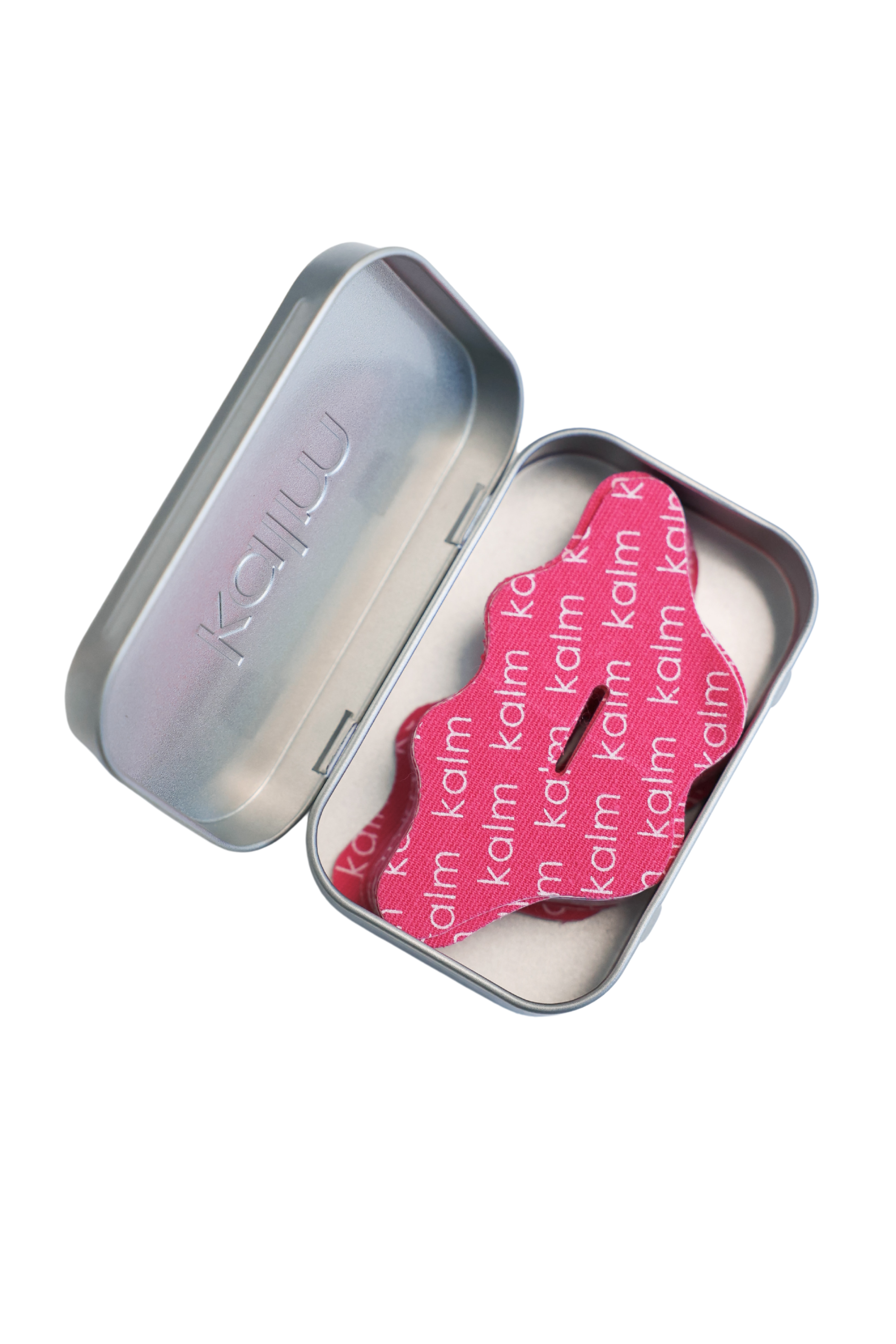 Open metal tin with a pink fabric item inside, labeled 'kalm.'
