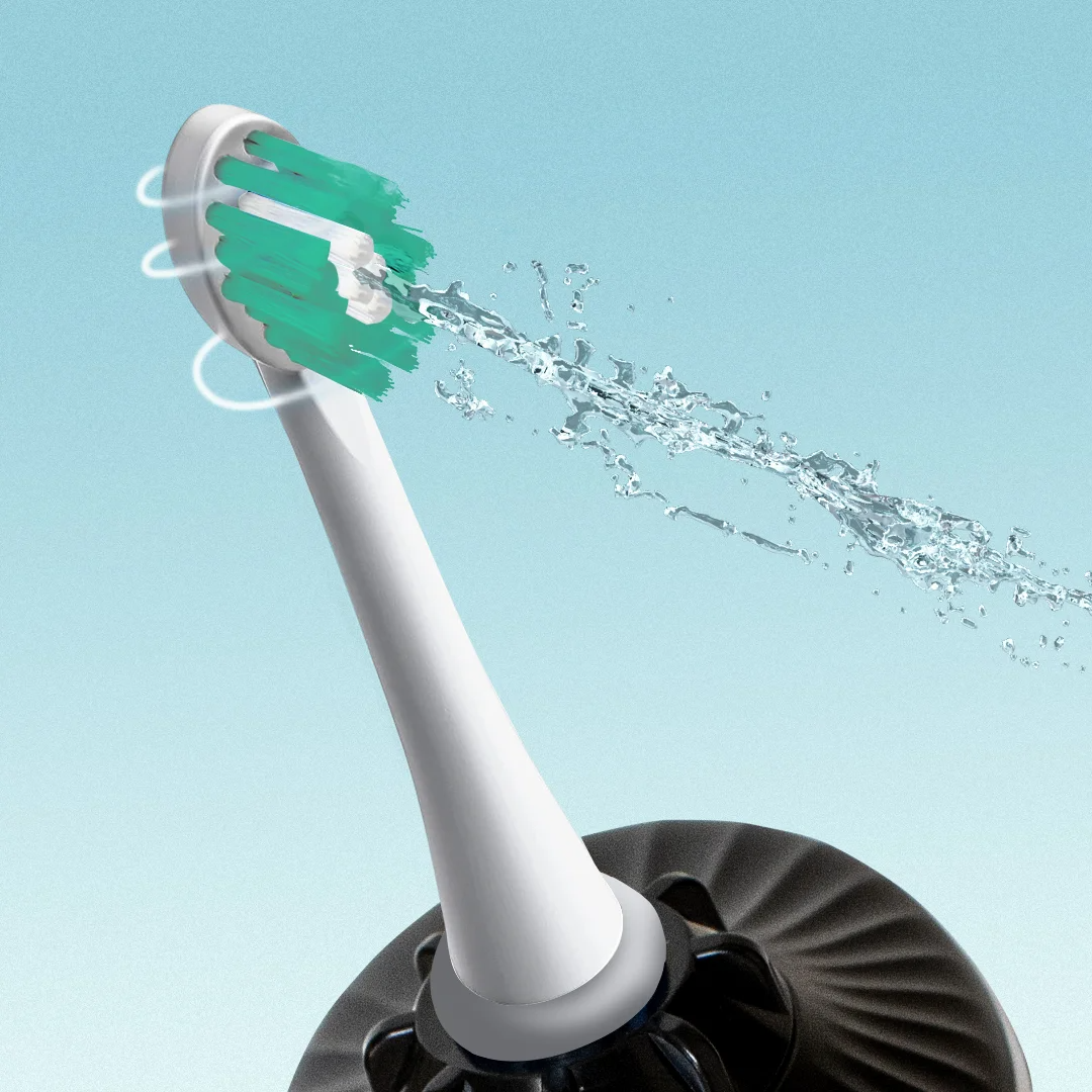 Electric toothbrush head with water splashing against a light blue background.