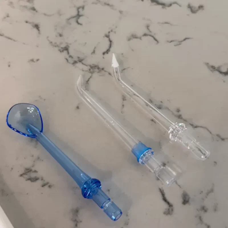 Three dental tools on a marble surface.