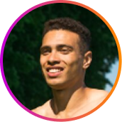 A circular headshot of a smiling young man outdoors with a purple-to-orange gradient border.
