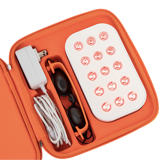 Orange case with LED light device, goggles, and power adapter.