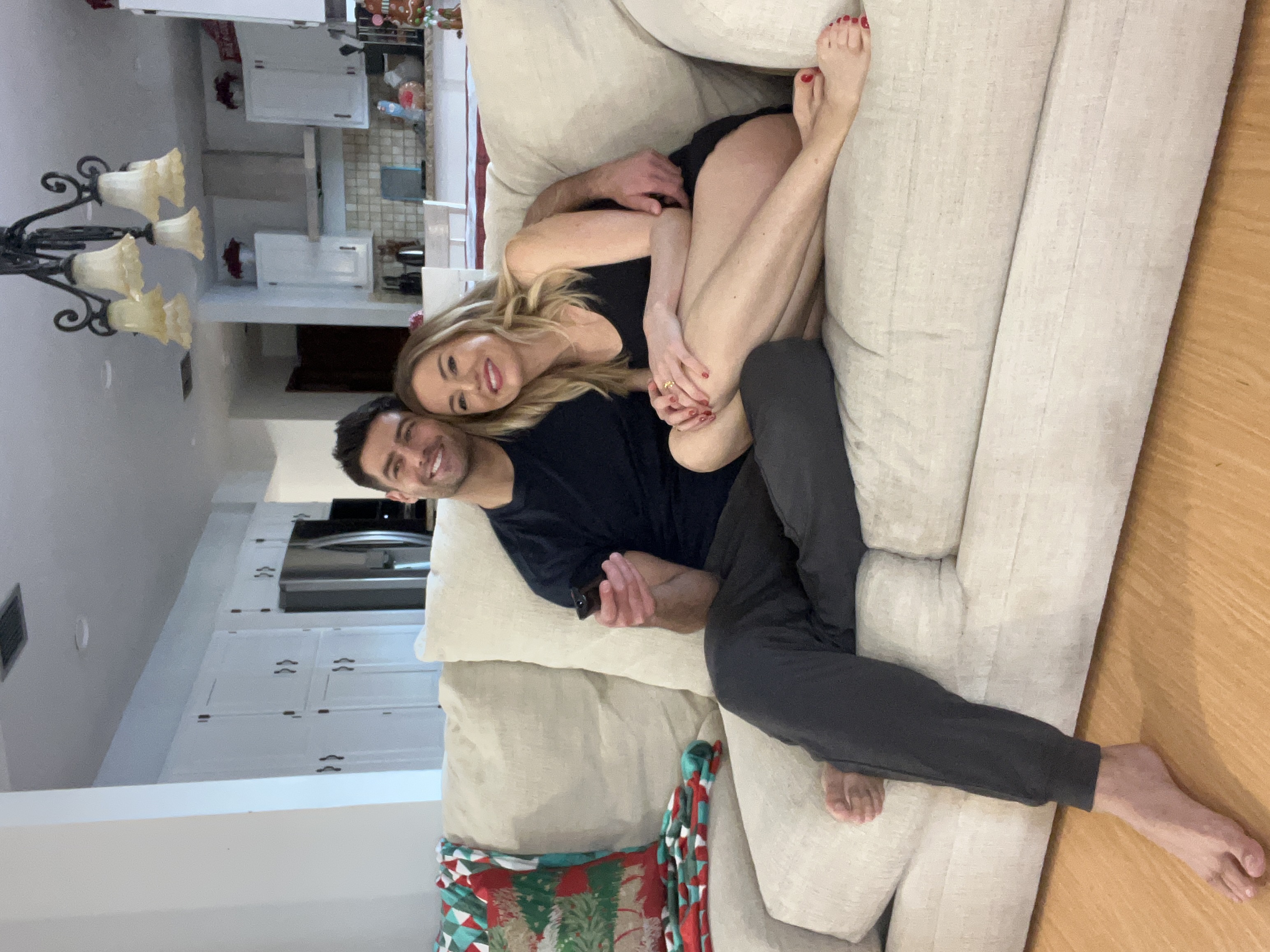 Couple relaxing on the couch, she wears the lounge set
