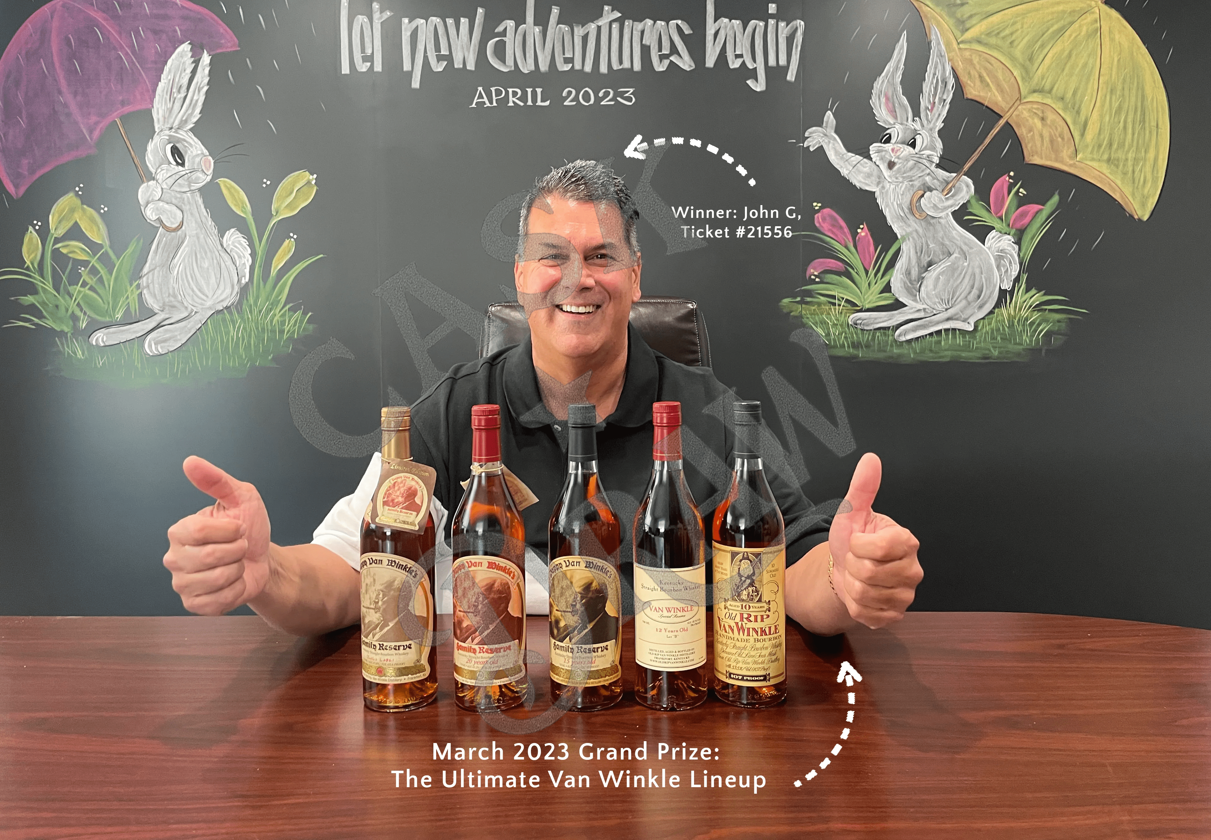 Man smiling with five bottles of Van Winkle whiskey on a table.