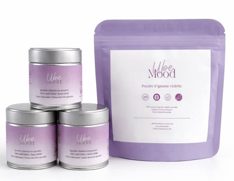 Three silver tins and one purple pouch of Ube Mood brand purple yam powder against a white background.