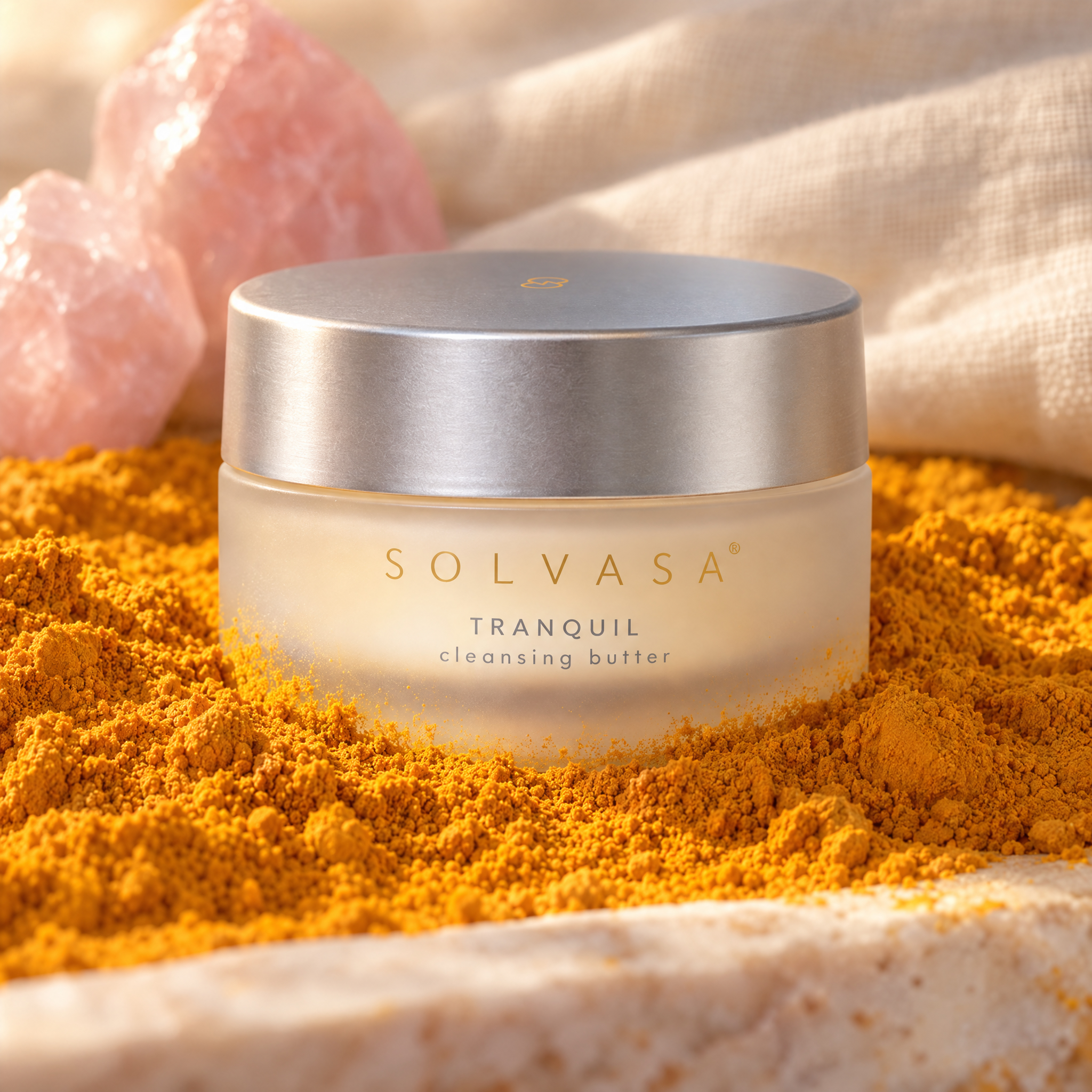 A jar of Solvasa cleansing butter sits in yellow powder, with pink crystals and a cloth in the background.
