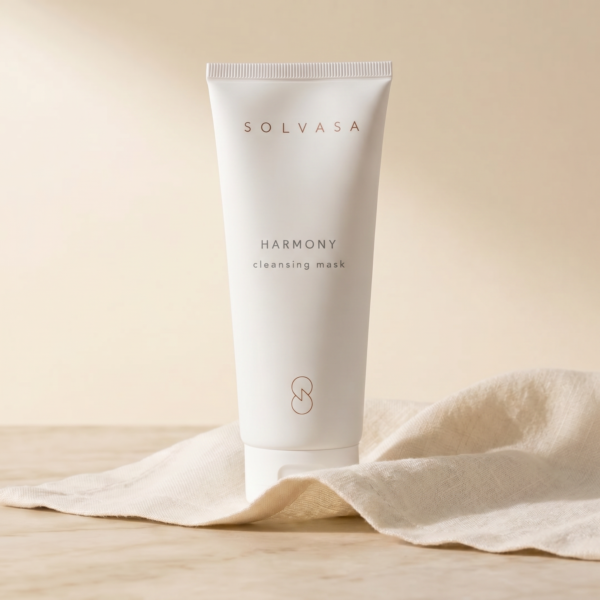 A white tube of Solvasa Harmony cleansing mask resting on a piece of folded cloth.