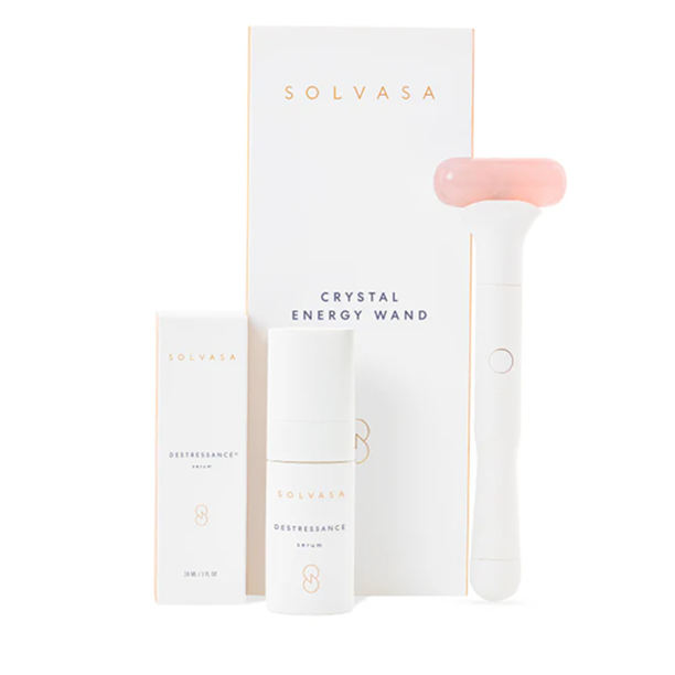 Cosmetic set with a crystal energy wand and serum bottles.
