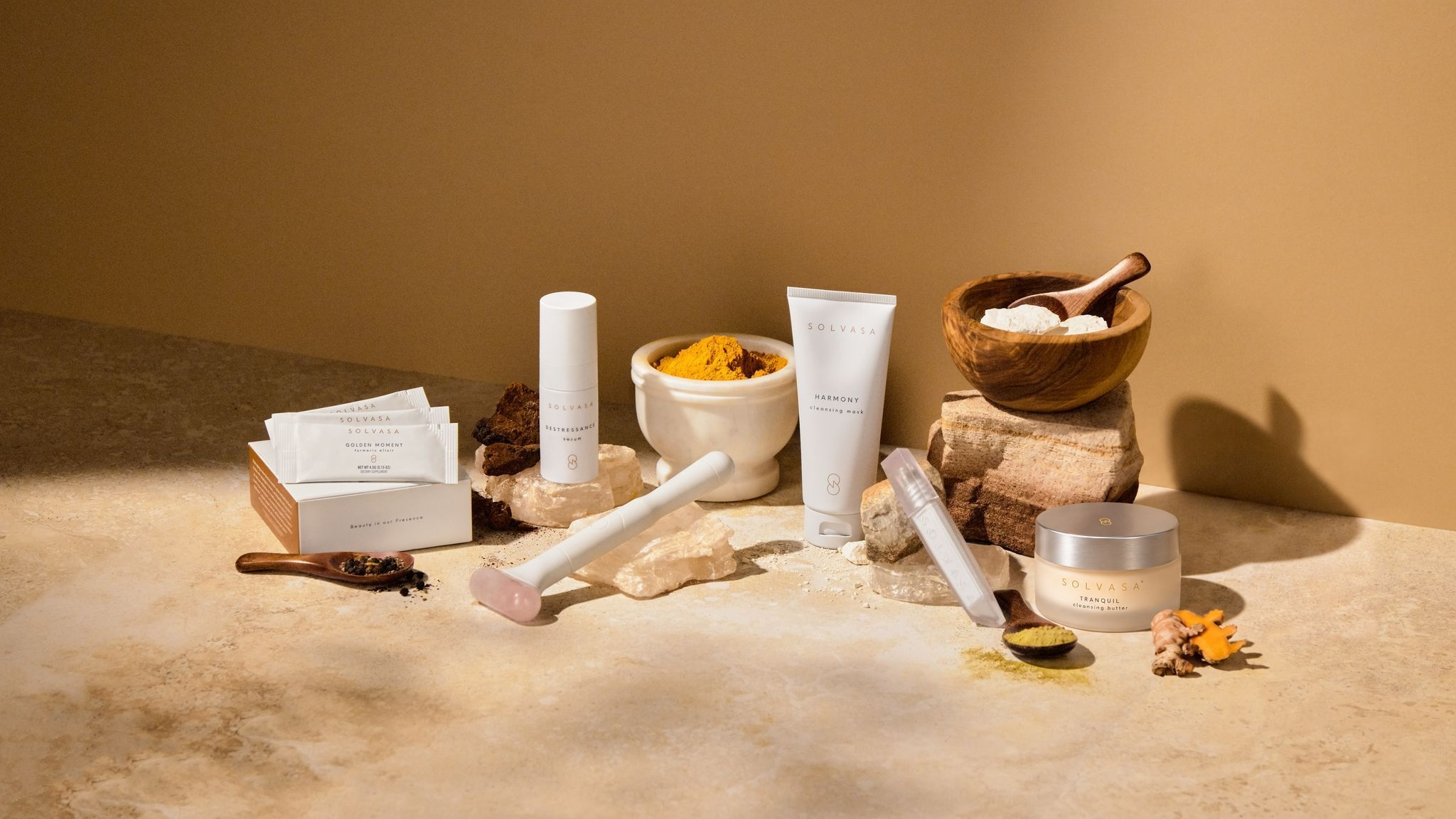 A collection of Solvasa skincare products arranged with natural ingredients and tools on a stone surface.