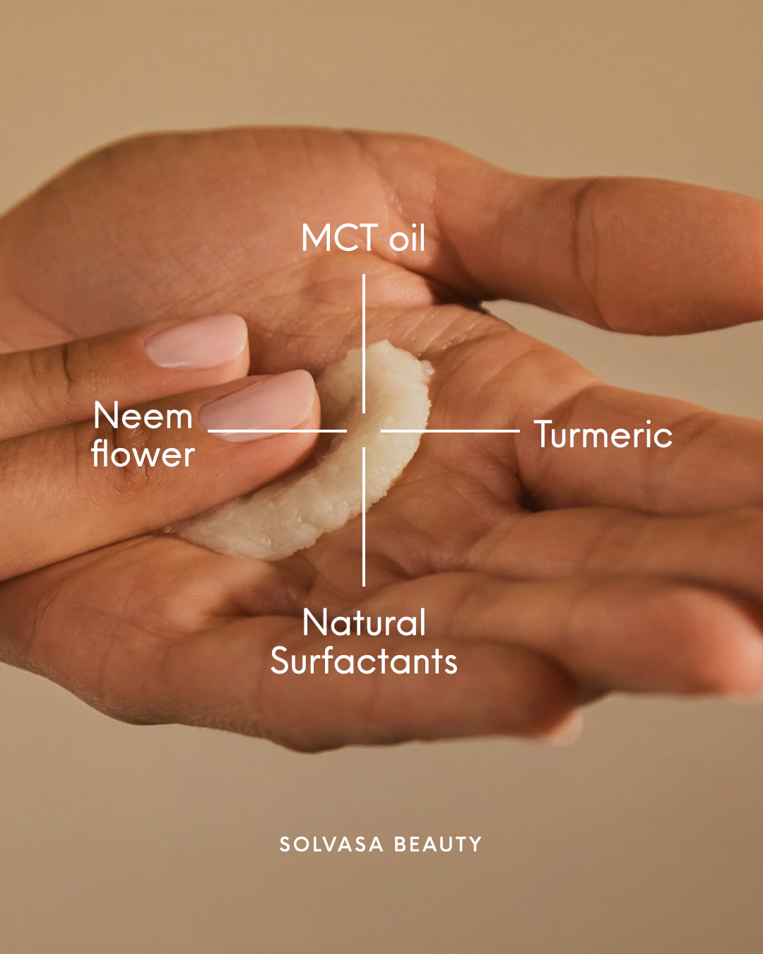 A close-up of a hand holding a white beauty product with text pointing out its ingredients.