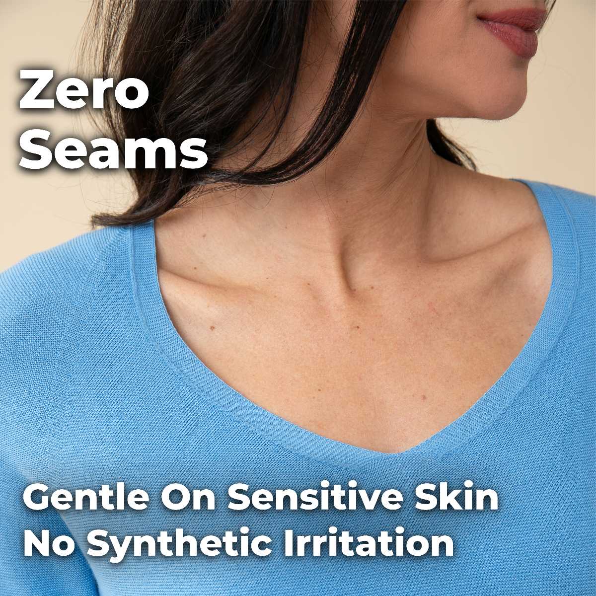 A close-up of a woman's neckline, wearing a light blue v-neck sweater.