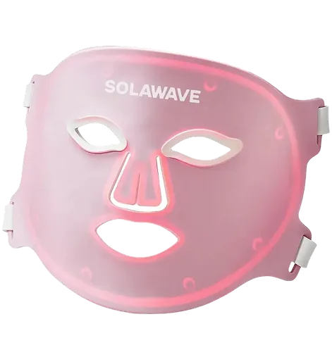 A translucent pink Solawave LED light therapy mask illuminated from within against a white background.
