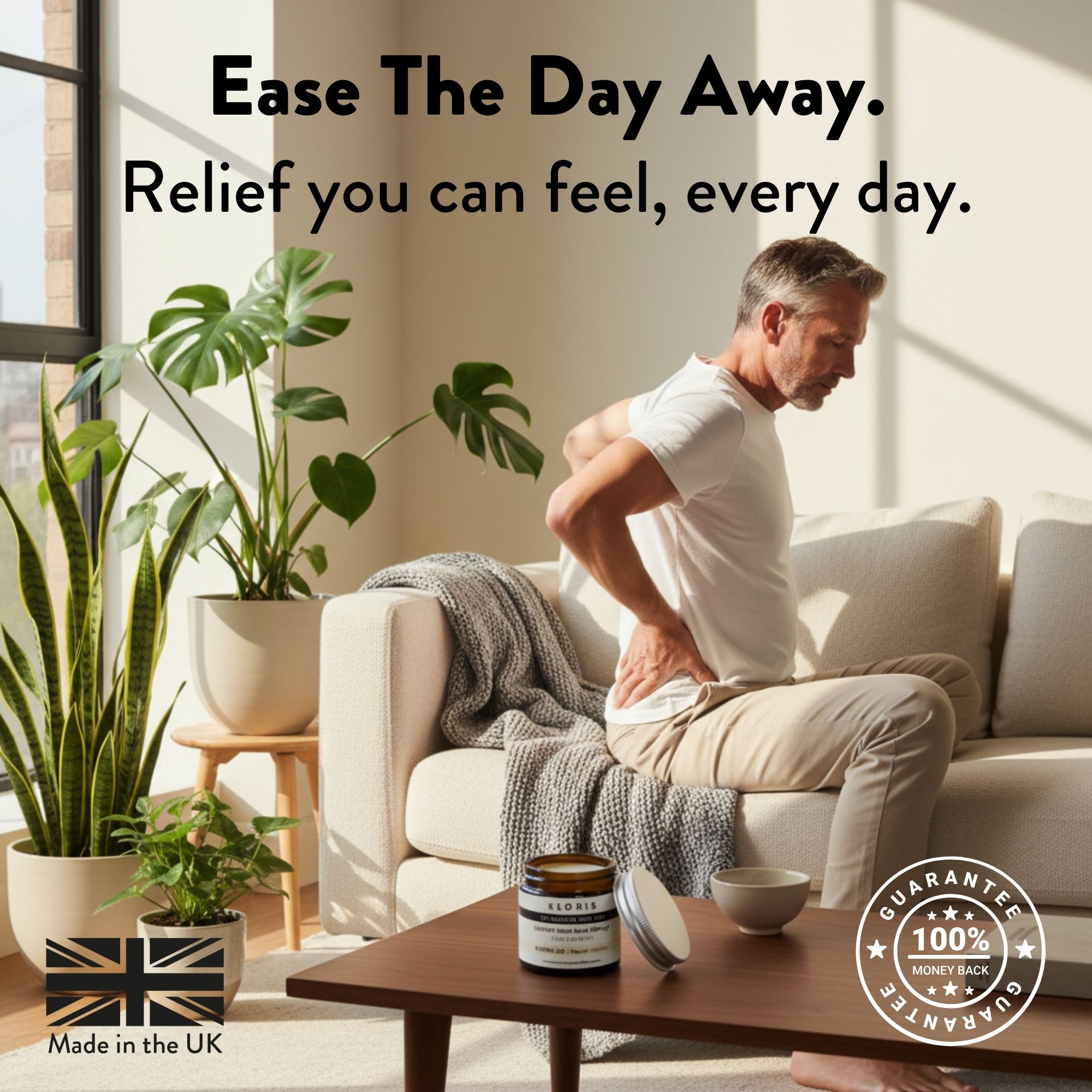 Man holding back on sofa, products on table with plants and large window.