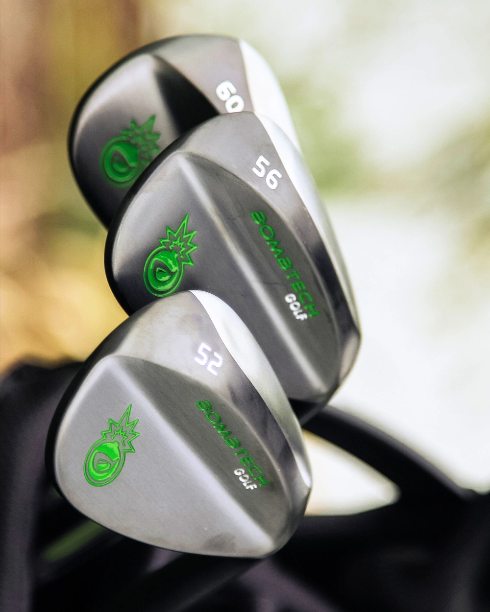 Three colorful golf clubs with a ribbon bow.