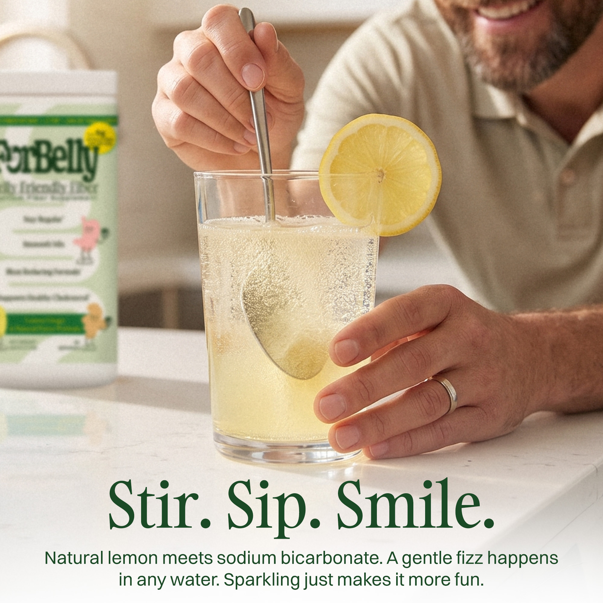 A man stirs a fizzy drink in a glass, garnished with a lemon slice, next to the product.