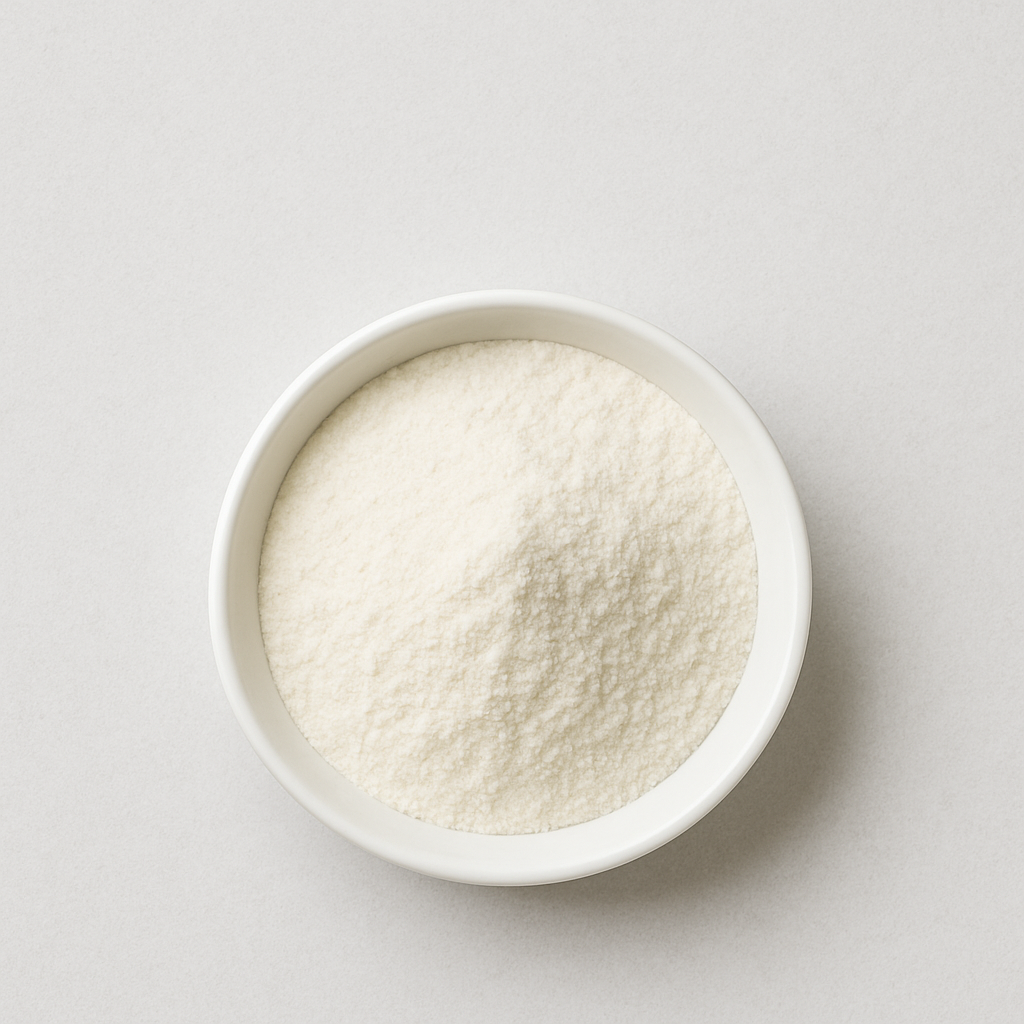 White powder in a small white bowl on a light background.