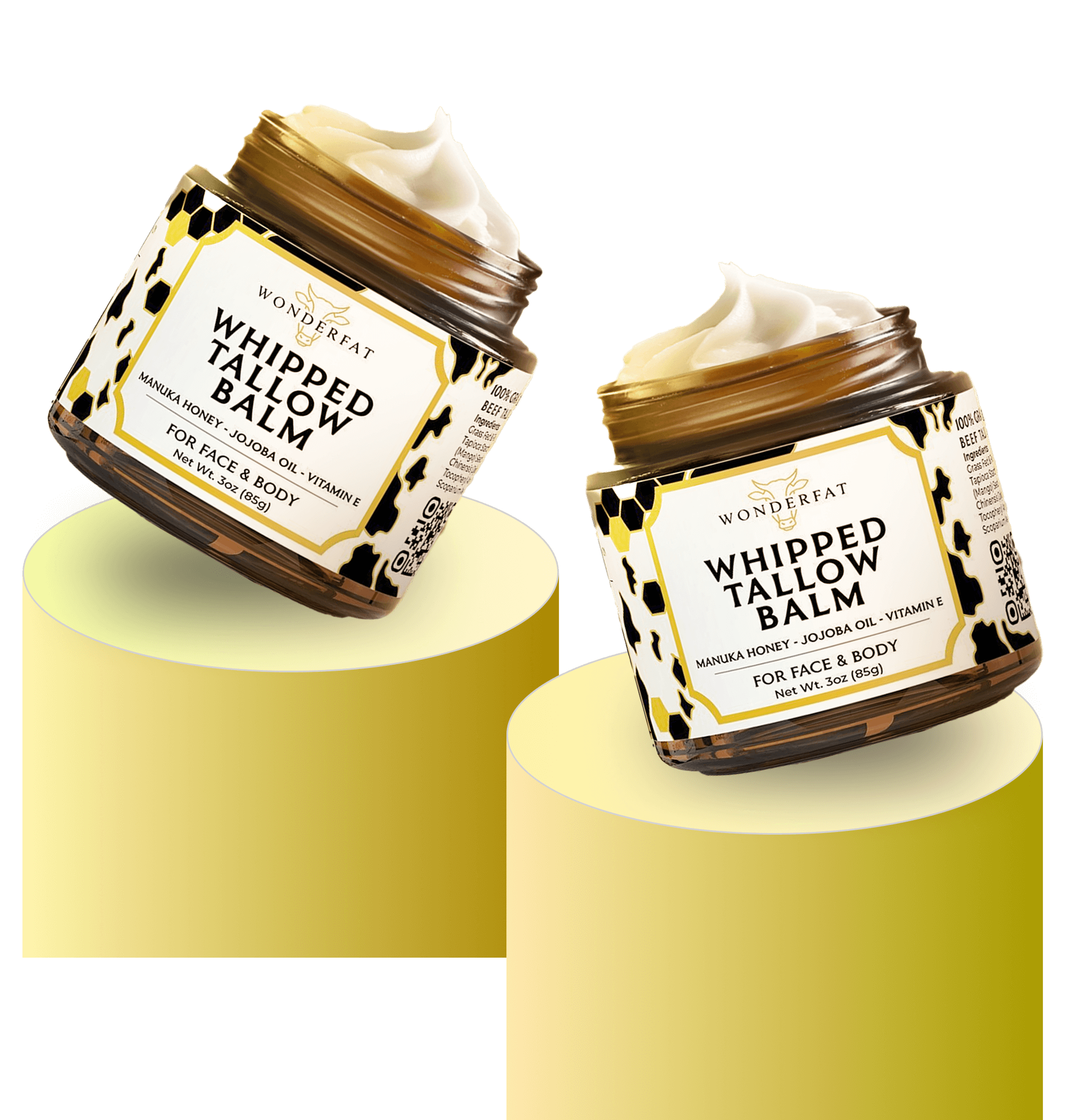 Two jars of Wonderfat Whipped Tallow Balm displayed on pastel yellow pedestals, highlighting ingredients like manuka honey, jojoba oil, and vitamin E for face and body hydration.