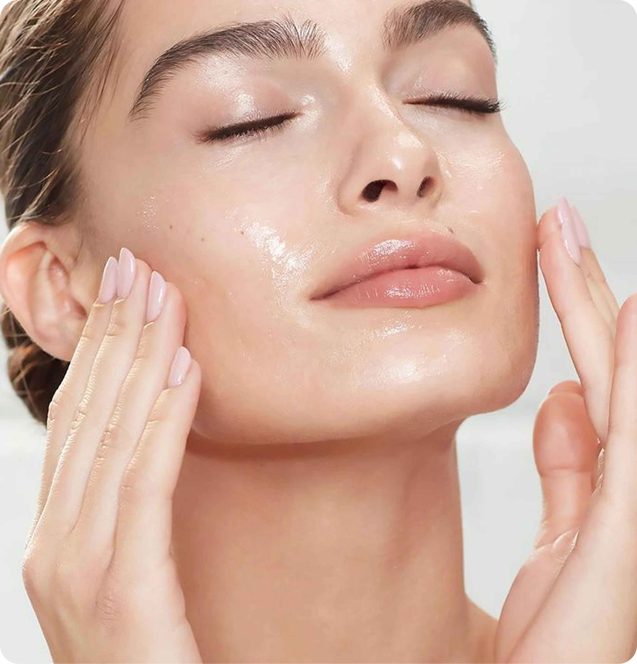 Woman applying Wonderfat Whipped Tallow Balm to her face, revealing deeply hydrated, dewy skin with a natural, radiant glow.