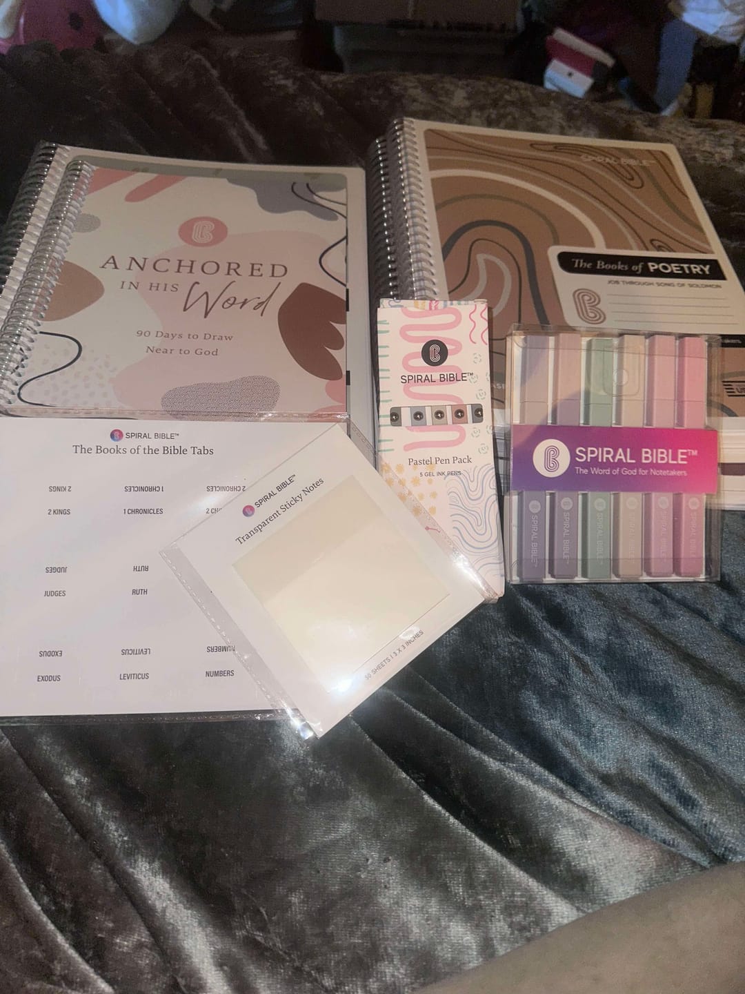 Open spiral notebook with highlighted text and handwritten notes on a desk.