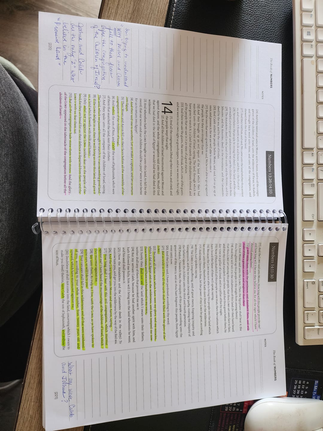 Open spiral notebook with highlighted text and handwritten notes on a desk.