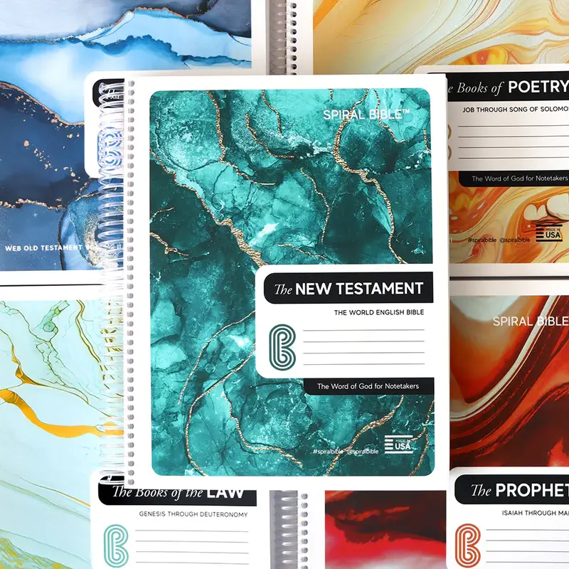 Colorful spiral-bound notebooks featuring different themed Bible sections.