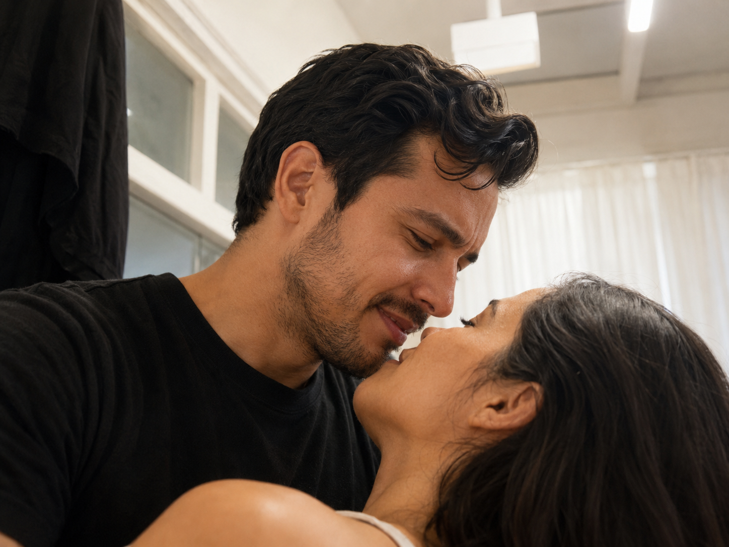 A close-up of a man and a woman face to face, about to kiss.