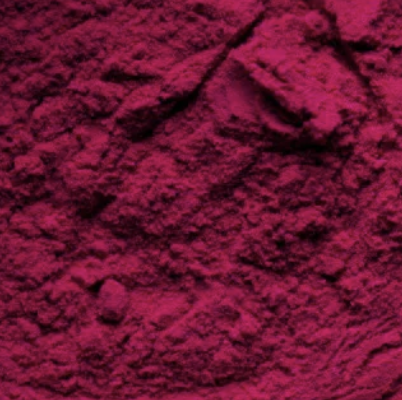 A close-up, macro view of a pile of bright magenta powder.