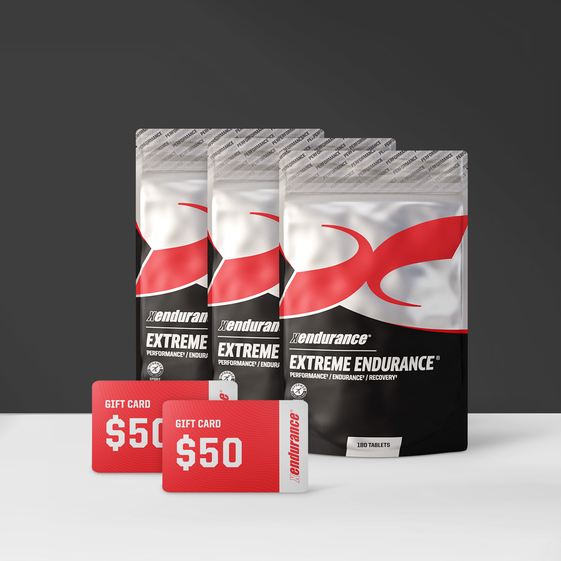 Three bags of Xendurance Extreme Endurance supplement standing behind two red $50 gift cards on a white surface.
