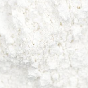 A close-up, pixelated view of a white, textured, powdery surface.