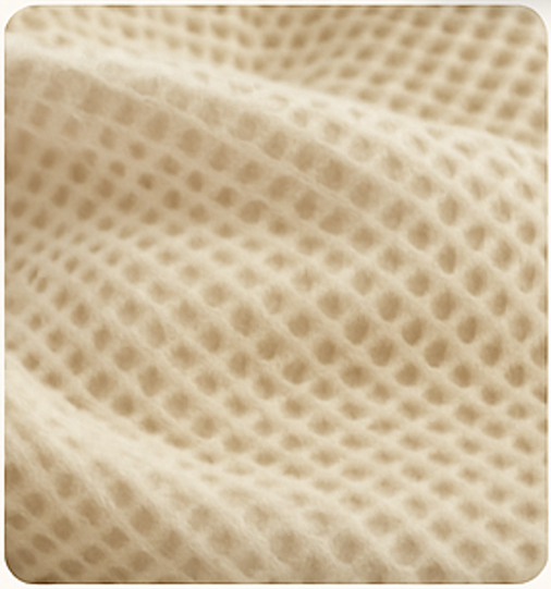 Beige textured fabric with a waffle-like pattern.