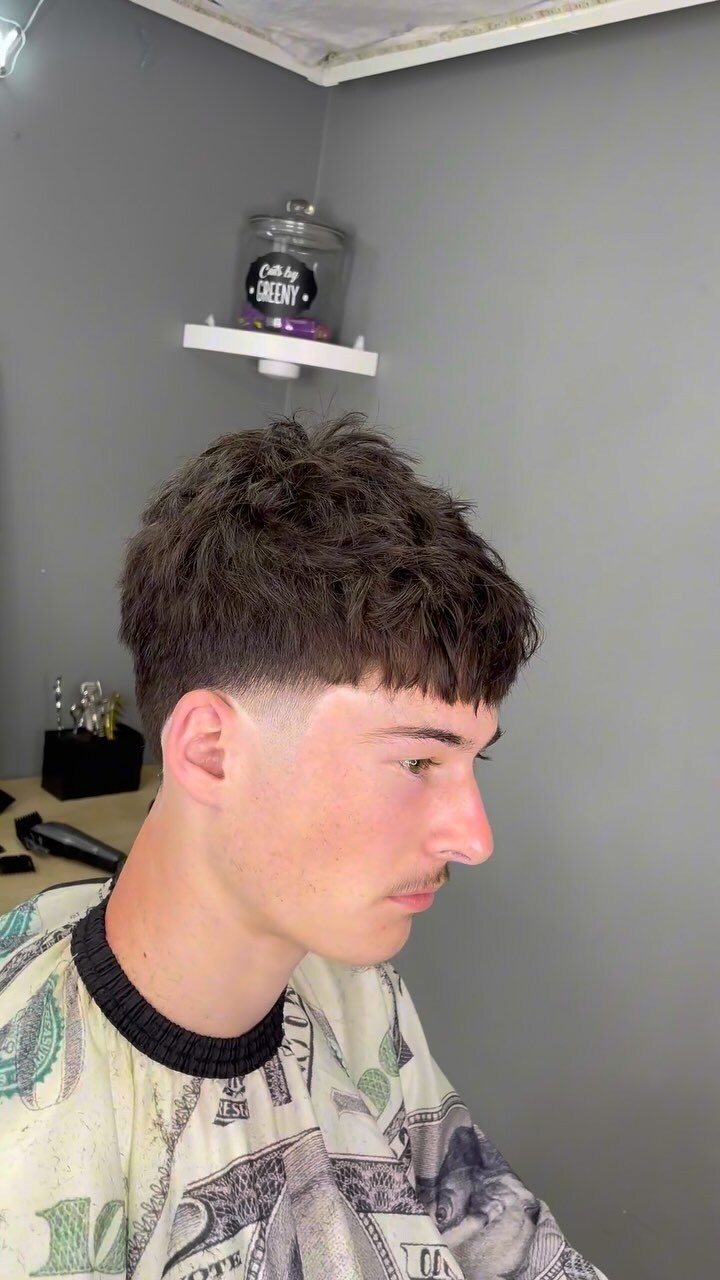 Person with short haircut in a barber shop.
