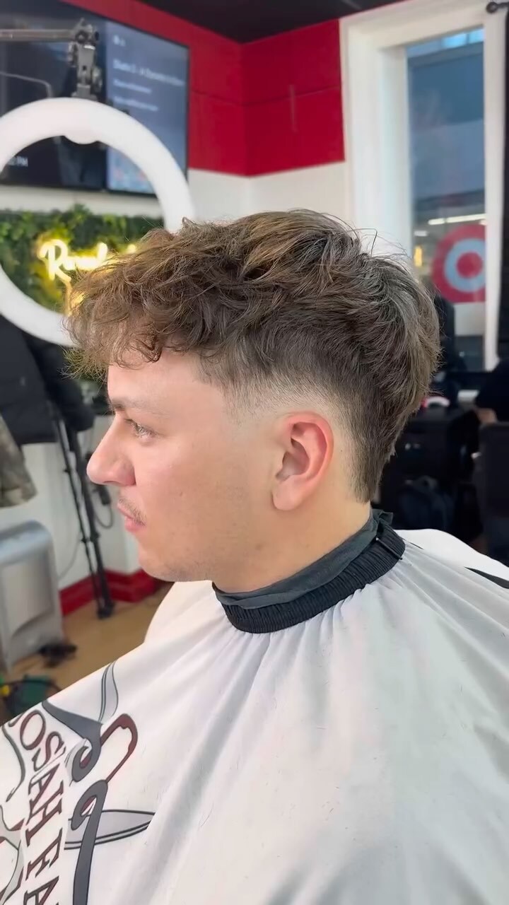 Man with a fresh haircut in a barbershop.