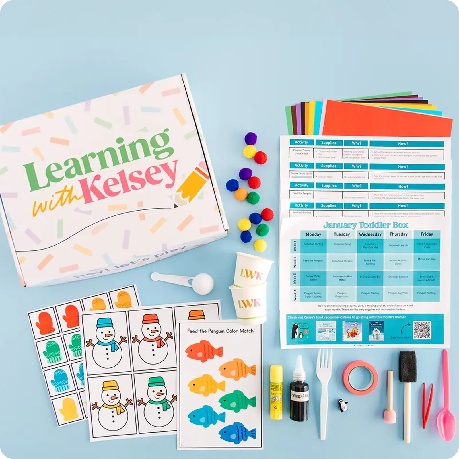 A flat lay of a 'Learning with Kelsey' toddler activity box and its various craft supplies and worksheets.
