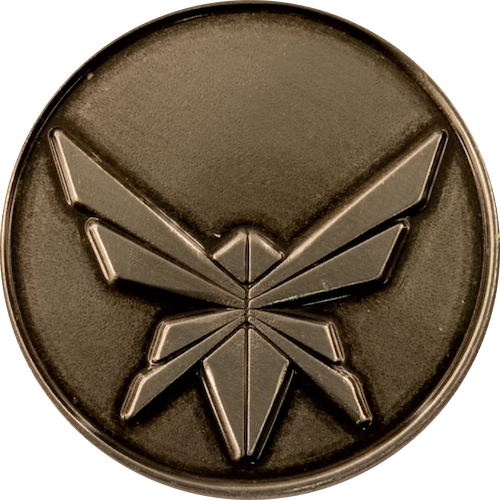A round emblem with a stylized insect design in the center.