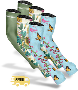 Three pairs of colorful socks with floral and butterfly designs.